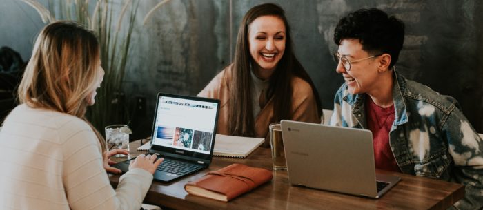 gen z at table with laptops